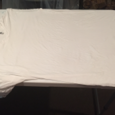Adult shirt, spread out over a table. Try to remove as many wrinkles as possible. The more crisp the edges, the better the outcome.